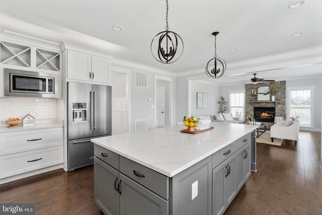 115 Saddle Ridge Ln, Fredericksburg, VA 22406 - kitchen featuring appliances with stainless steel finishes, gray cabinets, a fireplace, a kitchen island, and a chandelier