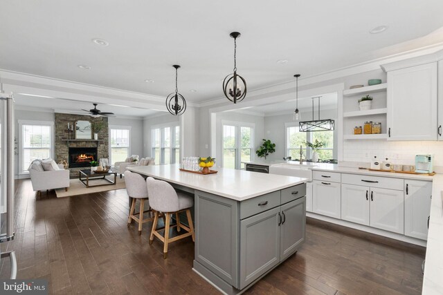 115 Saddle Ridge Ln, Fredericksburg, VA 22406 - kitchen featuring crown molding, gray cabinetry, dark wood-style flooring, open shelves, and a kitchen island