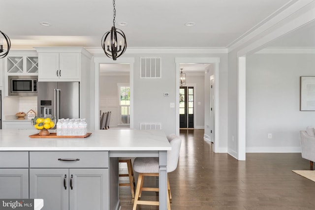 115 Saddle Ridge Ln, Fredericksburg, VA 22406 - kitchen with appliances with stainless steel finishes, a chandelier, light countertops, dark wood-style flooring, and ornamental molding