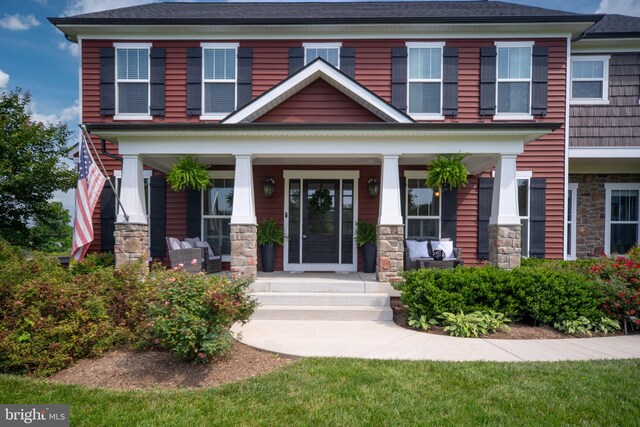 115 Saddle Ridge Ln, Fredericksburg, VA 22406 - view of front of house with stone siding, covered porch, and a shingled roof