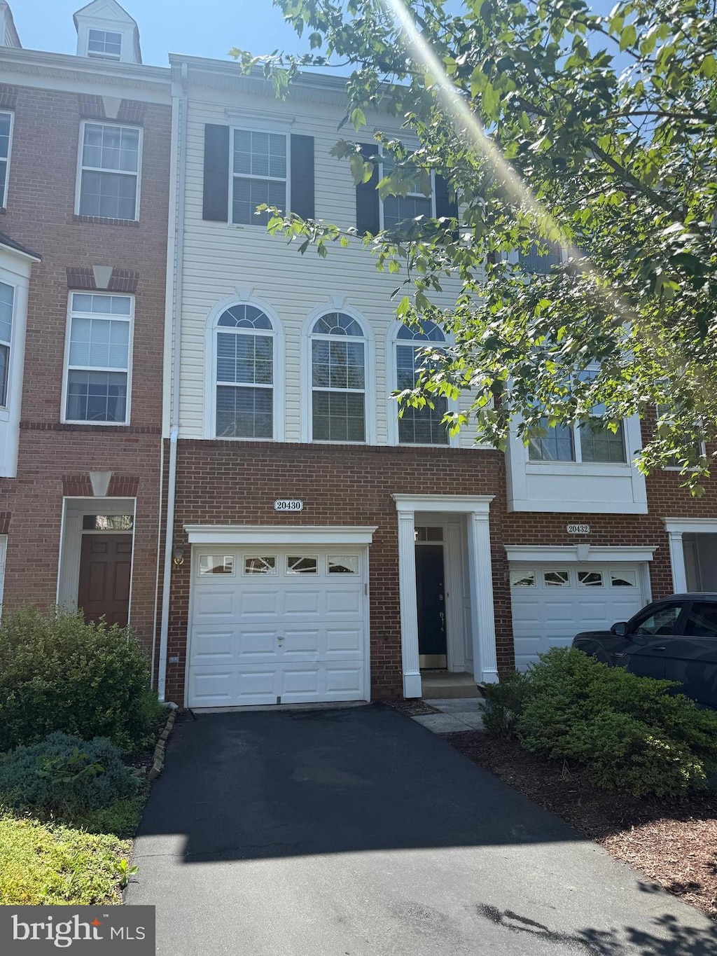 20430 Chetwood Ter, Ashburn, VA 20147 - multi unit property with an attached garage, driveway, and brick siding