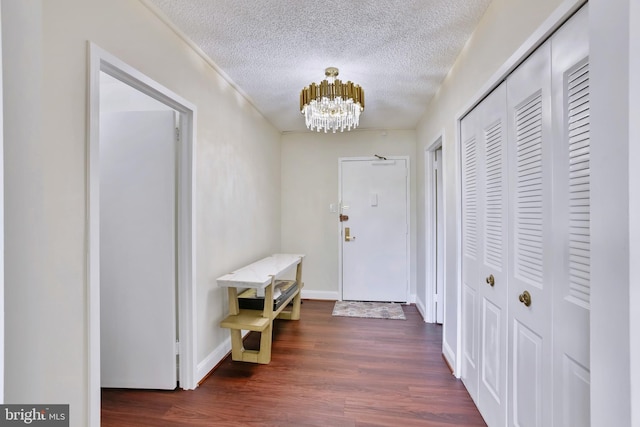 3701 S George Mason Dr Unit 205N, Falls Church, VA 22041 - hallway with a chandelier, a textured ceiling, and dark wood finished floors
