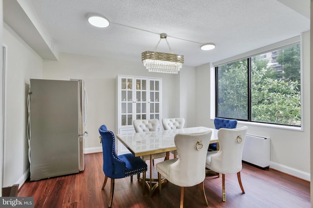 3701 S George Mason Dr Unit 205N, Falls Church, VA 22041 - dining room featuring a textured ceiling, dark wood finished floors, and a chandelier