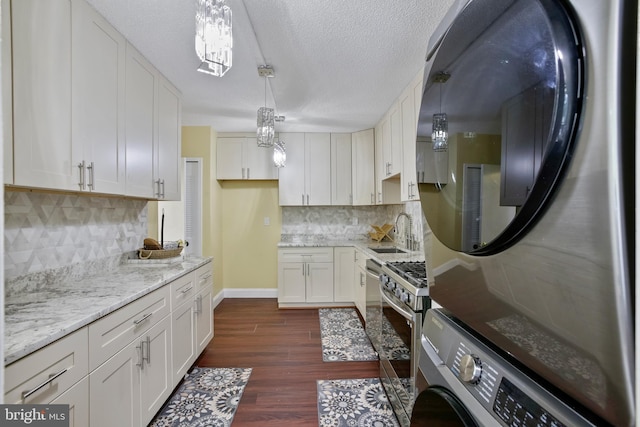 3701 S George Mason Dr Unit 205N, Falls Church, VA 22041 - kitchen featuring fridge, estacked washer and dryer, dark wood-style floors, tasteful backsplash, and light stone countertops