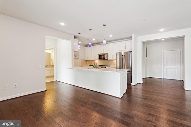 3989 Norton Pl Unit 207, Fairfax, VA 22030 - kitchen featuring appliances with stainless steel finishes, a peninsula, backsplash, light countertops, and dark wood finished floors