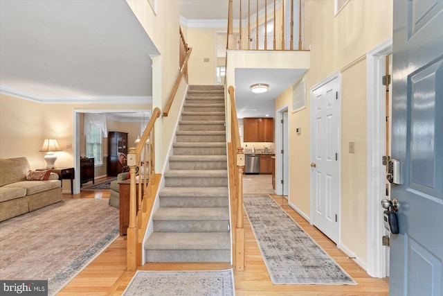 10 Frantz Ct, Fredericksburg, VA 22405 - foyer entrance with light wood-style flooring, crown molding, stairway, and a high ceiling