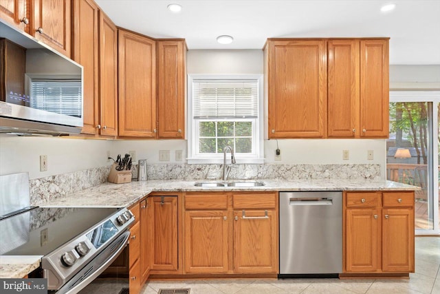 10 Frantz Ct, Fredericksburg, VA 22405 - kitchen featuring appliances with stainless steel finishes, light stone counters, brown cabinetry, recessed lighting, and light tile patterned flooring