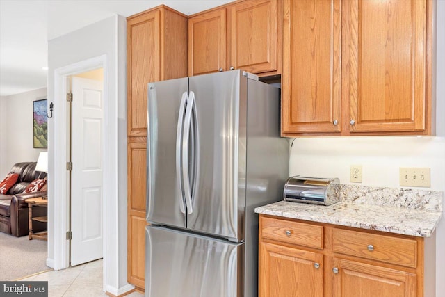 10 Frantz Ct, Fredericksburg, VA 22405 - kitchen with freestanding refrigerator, light stone countertops, and light tile patterned floors