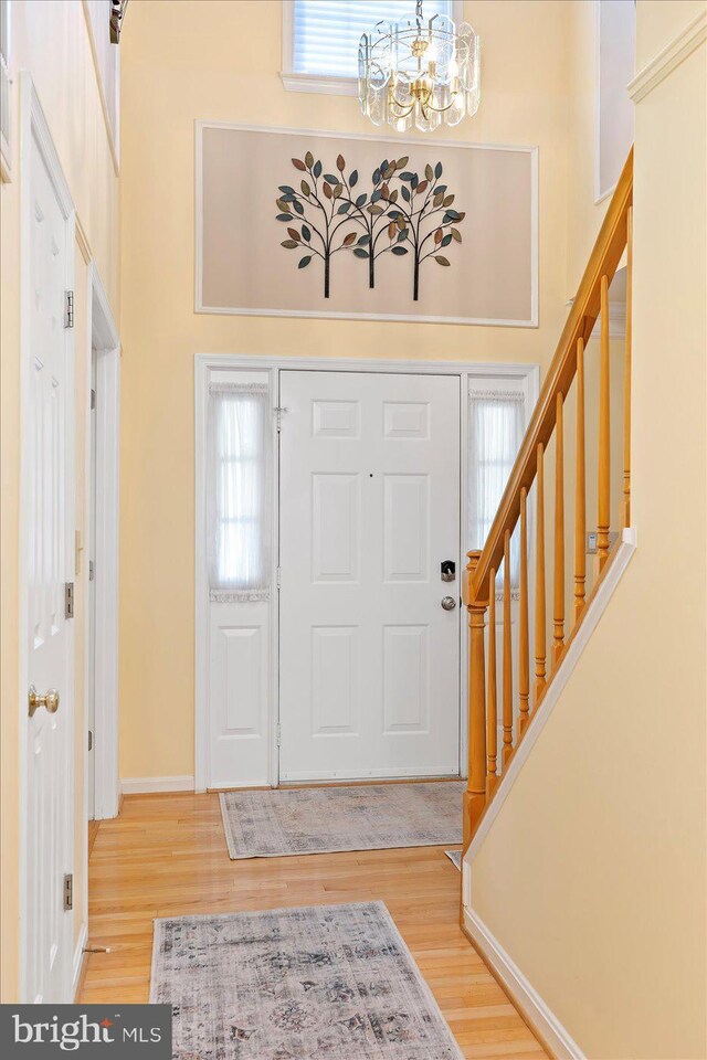 10 Frantz Ct, Fredericksburg, VA 22405 - foyer entrance with stairway, a chandelier, light wood-style floors, and a high ceiling