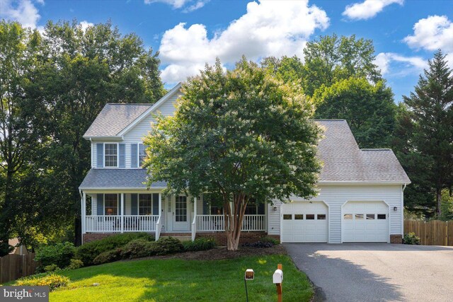 10 Frantz Ct, Fredericksburg, VA 22405 - view of property hidden behind natural elements with driveway, an attached garage, covered porch, and roof with shingles