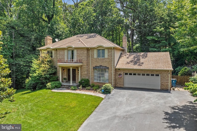 9100 Quarter Ct, Vienna, VA 22182 - view of front of property featuring a chimney, asphalt driveway, an attached garage, brick siding, and a balcony