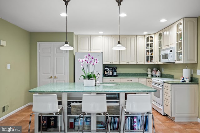 9100 Quarter Ct, Vienna, VA 22182 - kitchen featuring white appliances, a center island, light tile patterned floors, light stone countertops, and pendant lighting