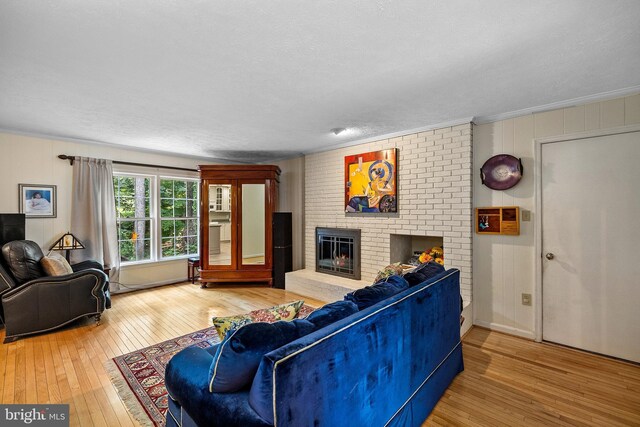 9100 Quarter Ct, Vienna, VA 22182 - living area with hardwood / wood-style flooring, a brick fireplace, crown molding, and a textured ceiling