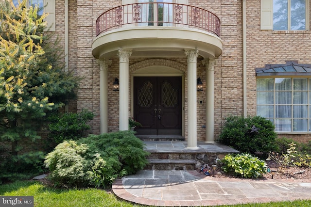 9100 Quarter Ct, Vienna, VA 22182 - view of exterior entry with a balcony and brick siding