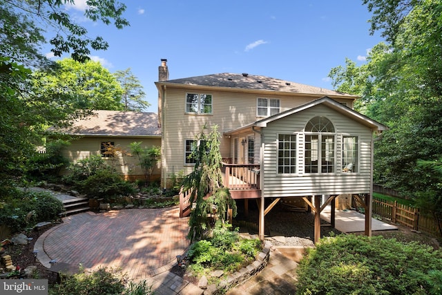 9100 Quarter Ct, Vienna, VA 22182 - back of property featuring a wooden deck, a chimney, and a patio area