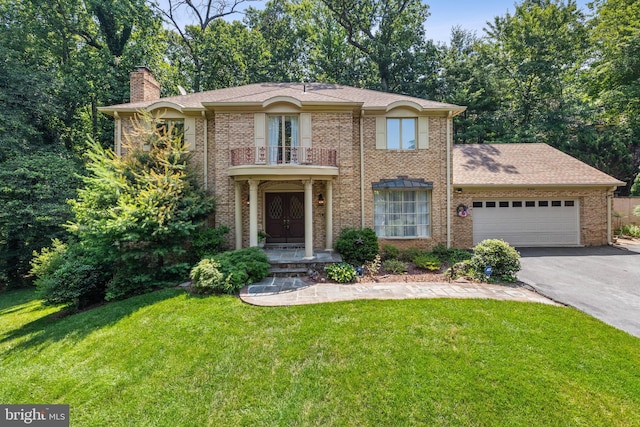 9100 Quarter Ct, Vienna, VA 22182 - view of front of property featuring a balcony, driveway, a garage, a chimney, and a front lawn