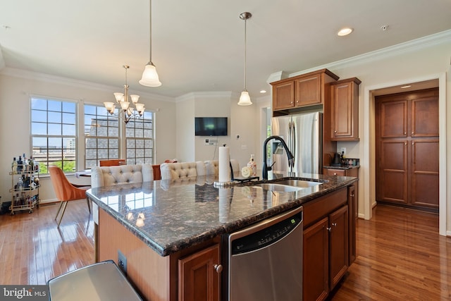 500 Overlook Park Drive 27, Oxon Hill, MD 20745 - kitchen featuring stainless steel appliances, wood finished floors, a center island with sink, brown cabinetry, and recessed lighting