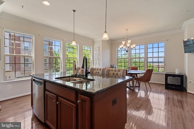 500 Overlook Park Drive 27, Oxon Hill, MD 20745 - kitchen featuring stainless steel dishwasher, healthy amount of natural light, wood-type flooring, dark stone counters, and ornamental molding
