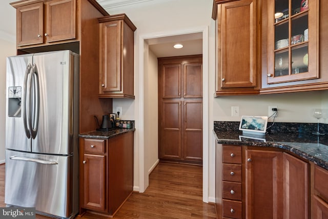 500 Overlook Park Drive 27, Oxon Hill, MD 20745 - kitchen featuring stainless steel fridge with ice dispenser, dark wood finished floors, brown cabinets, glass insert cabinets, and dark stone counters