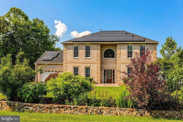 13336 Braddock Rd, Clifton, VA 20124 - view of front of home with roof mounted solar panels, an attached garage, and brick siding