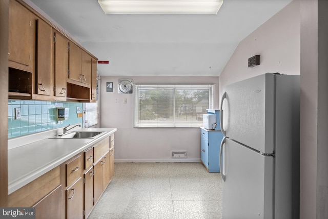 64 Warwick Rd, Stratford, NJ 08084 - kitchen with freestanding refrigerator, light floors, light countertops, and lofted ceiling