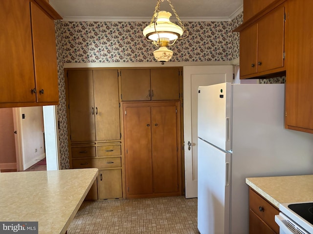 400 E Main St, Ephrata, PA 17522 - kitchen featuring wallpapered walls, light countertops, ornamental molding, range, and brown cabinets