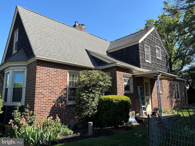 400 E Main St, Ephrata, PA 17522 - view of home's exterior with brick siding, a chimney, and roof with shingles