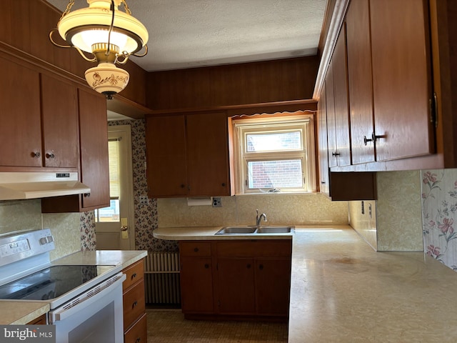 400 E Main St, Ephrata, PA 17522 - kitchen featuring white range with electric stovetop, under cabinet range hood, light countertops, decorative backsplash, and a textured ceiling