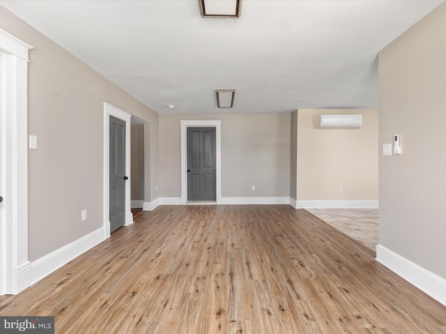232 Crawford St, Strasburg, VA 22657 - empty room with a wall unit AC and wood finished floors