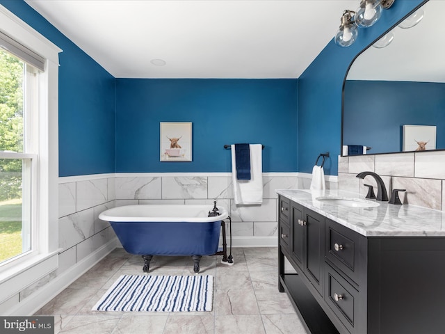 232 Crawford St, Strasburg, VA 22657 - bathroom featuring vanity, a freestanding bath, marble finish floors, wainscoting, and tile walls