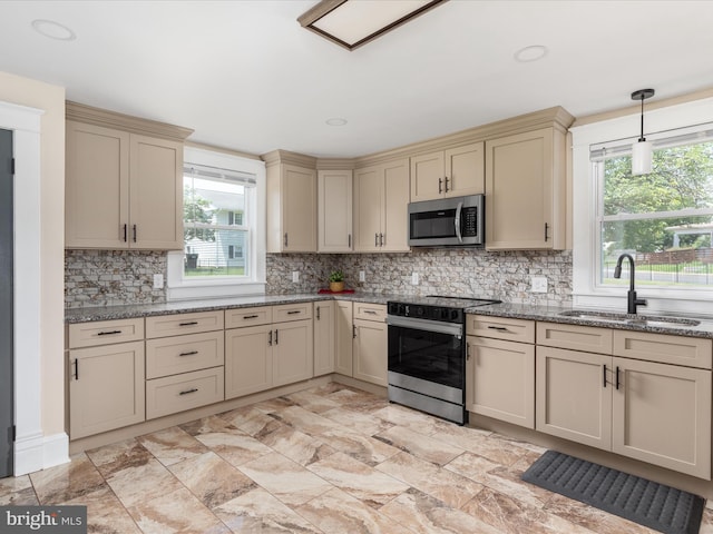 232 Crawford St, Strasburg, VA 22657 - kitchen featuring appliances with stainless steel finishes, cream cabinetry, plenty of natural light, and light stone counters