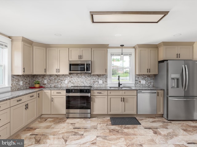 232 Crawford St, Strasburg, VA 22657 - kitchen featuring stainless steel appliances, cream cabinets, light stone counters, decorative backsplash, and hanging light fixtures