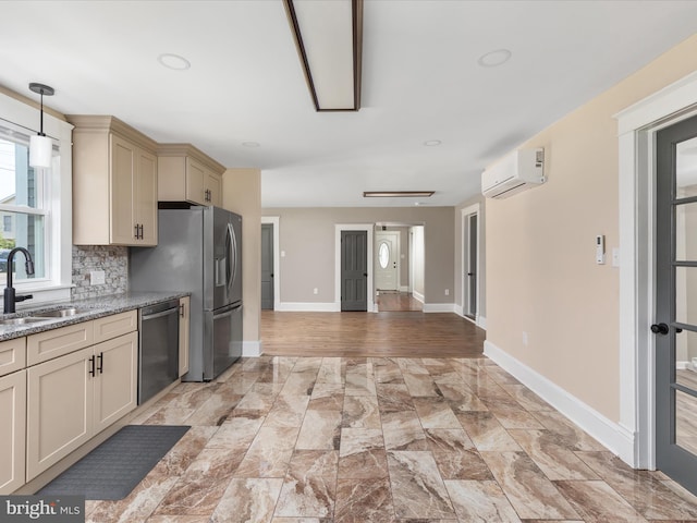 232 Crawford St, Strasburg, VA 22657 - kitchen featuring stainless steel appliances, cream cabinets, a wall unit AC, backsplash, and light stone counters