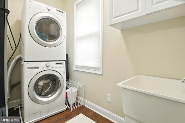 110 S Washington St, Havre De Grace, MD 21078 - laundry area with estacked washer and dryer, dark wood-type flooring, and cabinet space