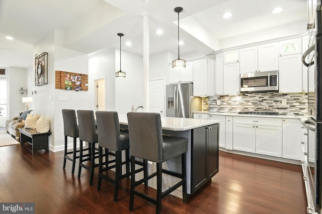 110 S Washington St, Havre De Grace, MD 21078 - kitchen with stainless steel appliances, backsplash, white cabinetry, and recessed lighting