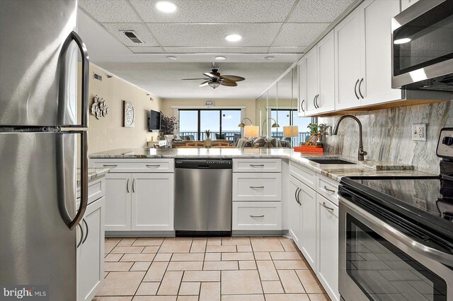 9800 Coastal Hwy Unit 1207, Ocean City, MD 21842 - kitchen with appliances with stainless steel finishes, ceiling fan, white cabinetry, light tile patterned flooring, and recessed lighting