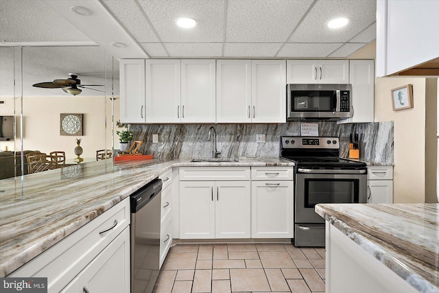 9800 Coastal Hwy Unit 1207, Ocean City, MD 21842 - kitchen with stainless steel appliances, white cabinetry, a ceiling fan, decorative backsplash, and recessed lighting