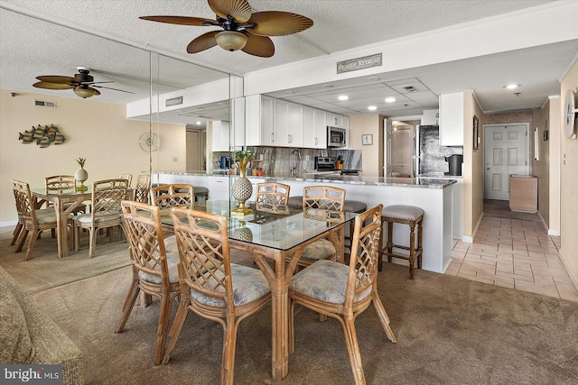 9800 Coastal Hwy Unit 1207, Ocean City, MD 21842 - dining space with a ceiling fan, light carpet, recessed lighting, a textured ceiling, and light tile patterned floors
