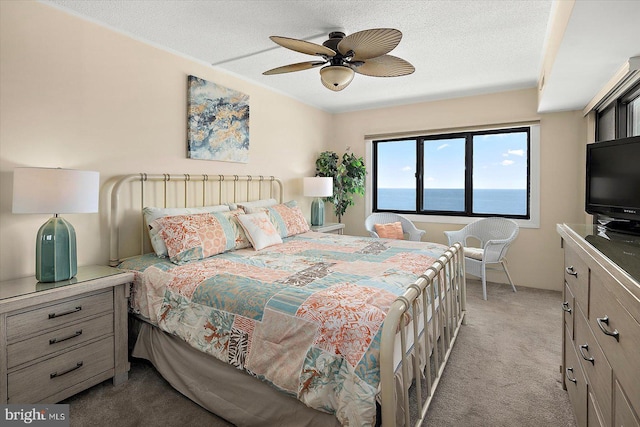 9800 Coastal Hwy Unit 1207, Ocean City, MD 21842 - bedroom with carpet flooring, a textured ceiling, and ceiling fan