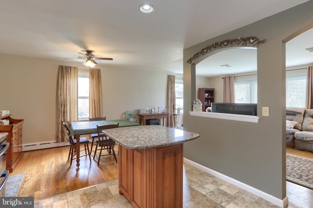 1002 S 2nd Ave, Lebanon, PA 17042 - kitchen featuring ceiling fan, recessed lighting, a kitchen island, light stone countertops, and arched walkways
