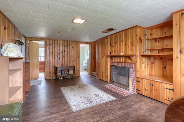 1002 S 2nd Ave, Lebanon, PA 17042 - living area featuring wood walls, a brick fireplace, and dark wood finished floors