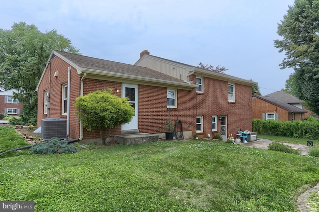 1002 S 2nd Ave, Lebanon, PA 17042 - back of house with a yard, a chimney, brick siding, roof with shingles, and a patio area