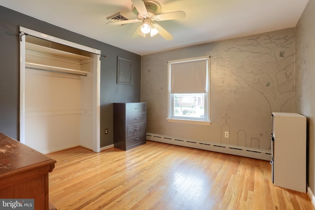 1002 S 2nd Ave, Lebanon, PA 17042 - unfurnished bedroom with a baseboard heating unit, light wood-style flooring, a ceiling fan, and a closet