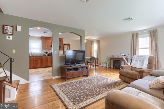 1002 S 2nd Ave, Lebanon, PA 17042 - living room featuring arched walkways, plenty of natural light, and light wood finished floors