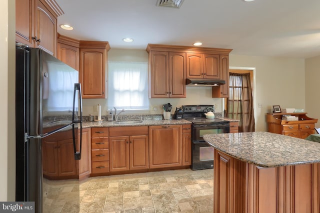 1002 S 2nd Ave, Lebanon, PA 17042 - kitchen featuring black appliances, under cabinet range hood, stone counters, recessed lighting, and brown cabinetry