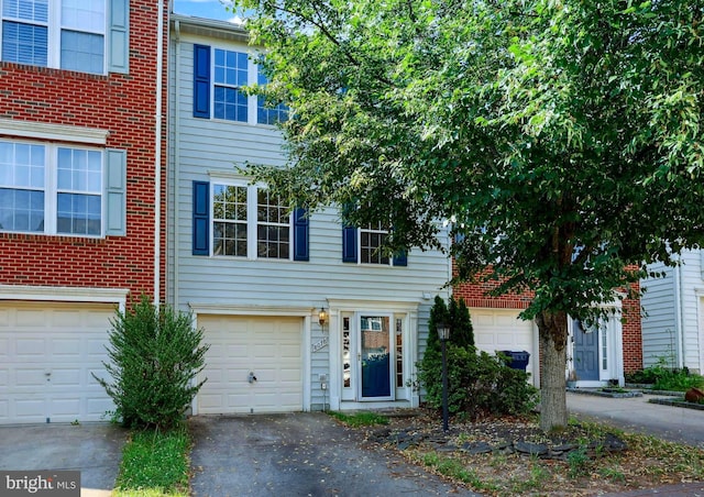 8078 Horseshoe Cottage Cir, Lorton, VA 22079 - multi unit property with asphalt driveway, brick siding, and a garage