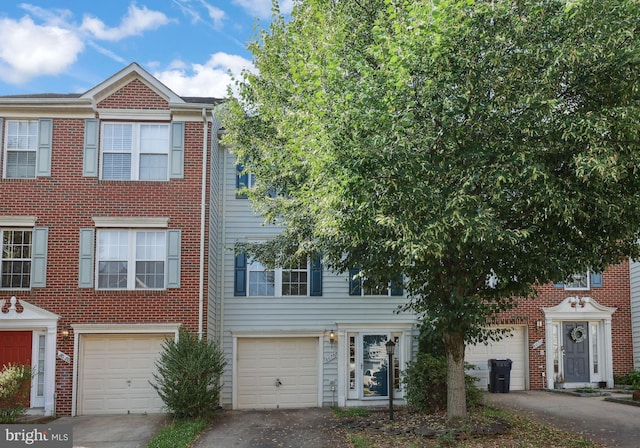 8078 Horseshoe Cottage Cir, Lorton, VA 22079 - view of property with brick siding, an attached garage, and driveway