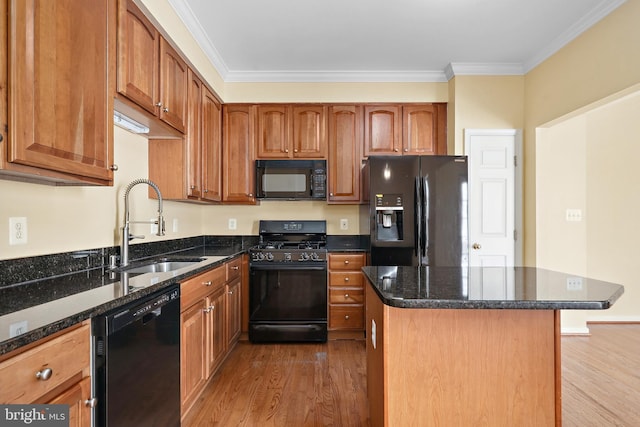 8078 Horseshoe Cottage Cir, Lorton, VA 22079 - kitchen featuring black appliances, wood finished floors, crown molding, dark stone counters, and a kitchen island