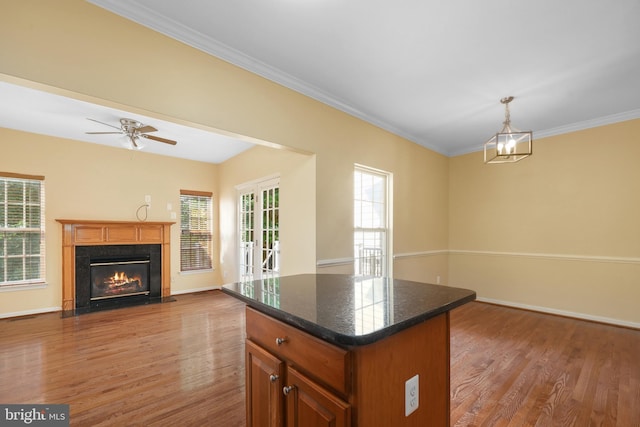 8078 Horseshoe Cottage Cir, Lorton, VA 22079 - kitchen with wood finished floors, open floor plan, a high end fireplace, a kitchen island, and crown molding