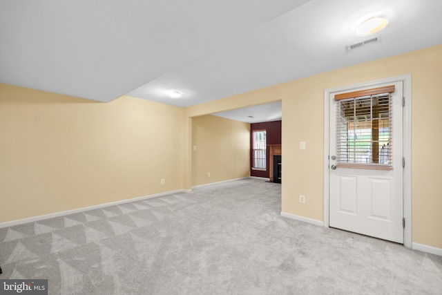 8078 Horseshoe Cottage Cir, Lorton, VA 22079 - unfurnished room with plenty of natural light, light colored carpet, and a fireplace with flush hearth